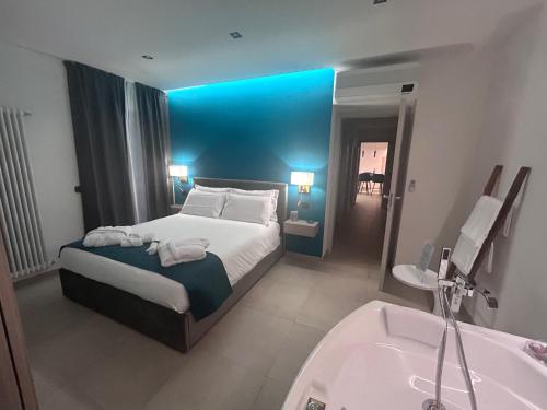 a hotel room with a bed and a bath tub at Lakes and Mountains Magic Holiday House in Omegna