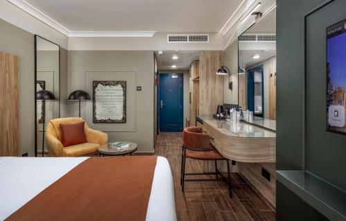 a hotel room with a king sized bed and a bar at Vivaldi Hotel in St Julian's