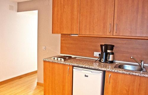 a kitchen with a sink and a counter top at BQ Augusta Hotel in Palma de Mallorca