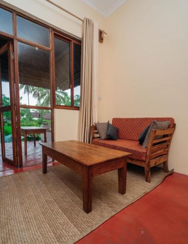 a living room with a couch and a coffee table at Maisara Mafia Beach Lodge in Kilindoni