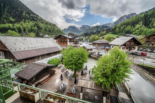 an overhead view of a town in a valley with mountains at L' Abbaye in Abondance