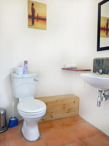 a bathroom with a toilet and a sink at Pine Valley in Lanseria