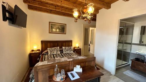 1 dormitorio con cama, TV y baño en B&B Domus iulii, en Cividale del Friuli