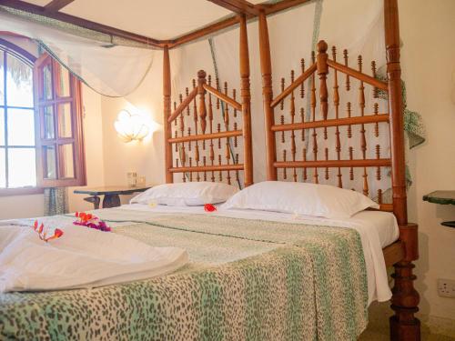 Postel nebo postele na pokoji v ubytování Tembo Baharini Apartments