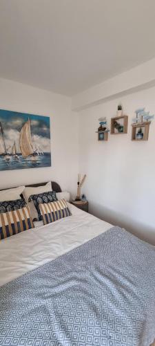 a bedroom with two beds and a painting on the wall at Chambre St-Loup in Saint-Mathieu-de-Tréviers