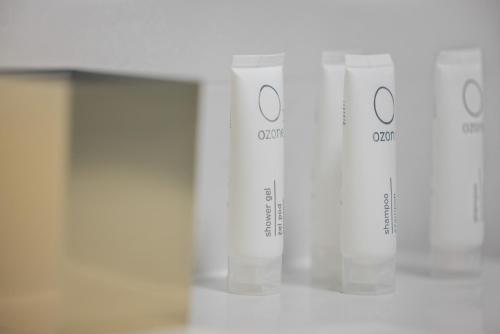 a row of white cups on a shelf at Sun & Beach Apartments Bel Mare with Parking by Noclegi Renters in Międzyzdroje