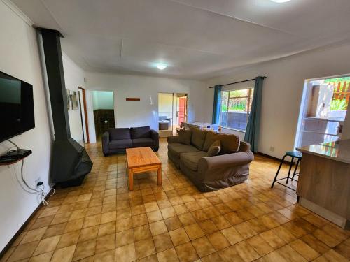 a living room with a couch and a table at Pine Valley in Lanseria
