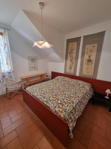 a bedroom with a bed with a comforter on it at Mia House in Porto Vecchio