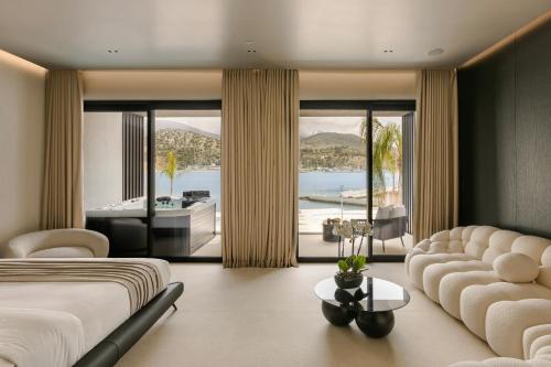 a bedroom with a bed and a living room at Casaly Hotel & Spa in Argostoli