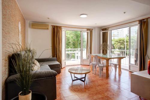 a living room with a couch and a table at Apartamentos Ducal Center de playa gandia in Playa de Gandia
