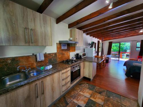 a kitchen with a sink and a stove top oven at Pine Valley in Lanseria