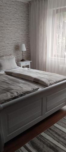 a bedroom with a large bed with a window at Ferienwohnung Belle Vue in Bernkastel-Kues