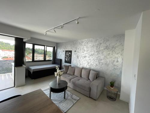 a living room with a couch and a table at Sandi Hvar Apartments in Hvar