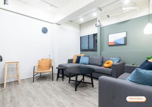 a living room with a couch and a table at Lin Suites by Olala Homes in Taipei