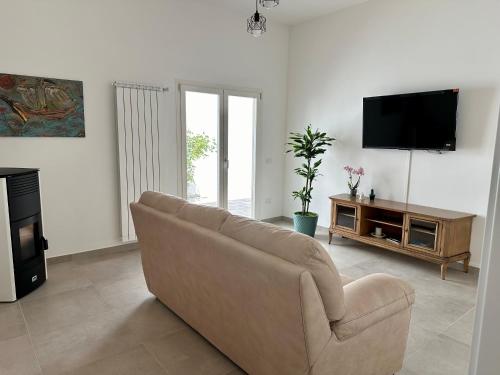 ein Wohnzimmer mit Couch und Flachbildfernseher in der Unterkunft AMA Home in Nardò