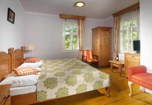 Postel nebo postele na pokoji v ubytování Hotel Pod Jasany