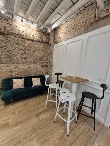 a room with a couch and a table and chairs at Hermosos Apartamentos en pleno Centro in Granada