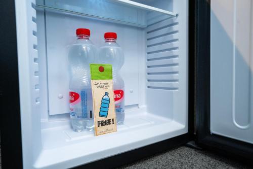 two bottles of water in an open refrigerator at Hotel Waldhorn in Bern