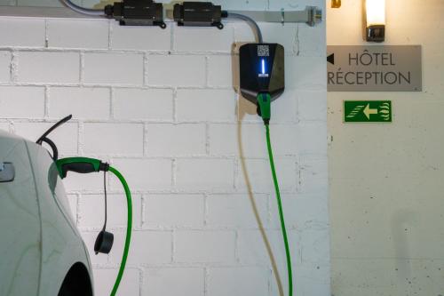 a green hose is hooked up to a hotel reception sign at Hotel Waldhorn in Bern