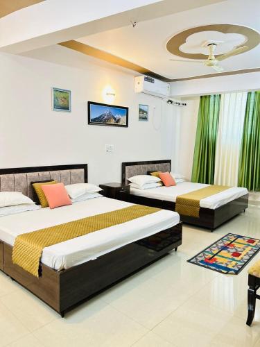 1 dormitorio con 2 camas y techo en Anandmay Homestay, ISBT Rishikesh en Rishīkesh