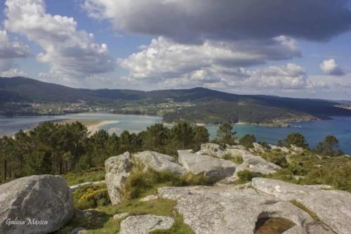 a view of a lake from a mountain with rocks at PONTECESO, MAR Y FER in Ponteceso