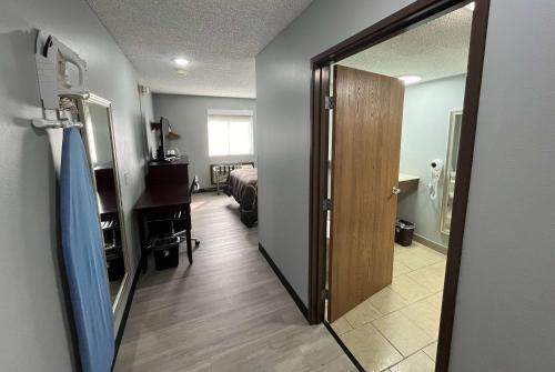 a room with a door leading to a bedroom at Super 8 by Wyndham Emporia in Emporia