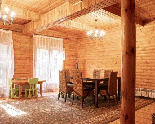 a dining room with a table and chairs at BOROVOE Country Club in Borovoye