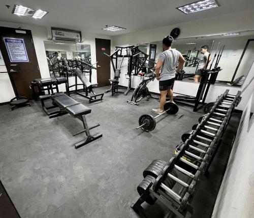 a man standing in a gym with several machines at City center + walk in closet in Cebu City