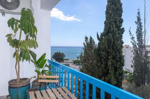 a balcony with a bench and a view of the ocean at White Arches Apt #2 by TrulyCyprus in Limassol