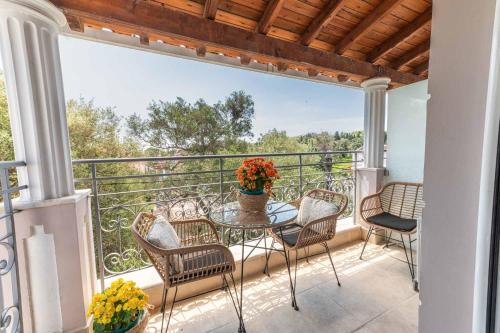 a patio with a table and chairs on a balcony at KORINA APART HOTEL KAVOS in Kavos