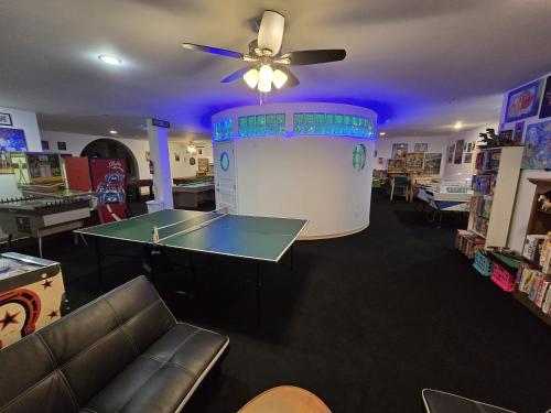 a ping pong table in a store with a ceiling fan at The Starlight Tower Manor, River, Arcades, Observatory, Theater in Fort Atkinson