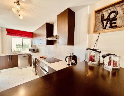 a kitchen with wooden cabinets and a counter top at El Horno in Adeje