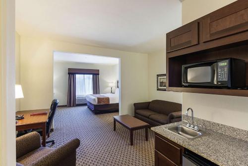 a hotel room with a bed and a living room at Comfort Suites San Antonio North - Stone Oak in San Antonio