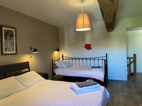 - une chambre avec 2 lits et un éclairage dans l'établissement La Maison des Coteaux, à Chadenac