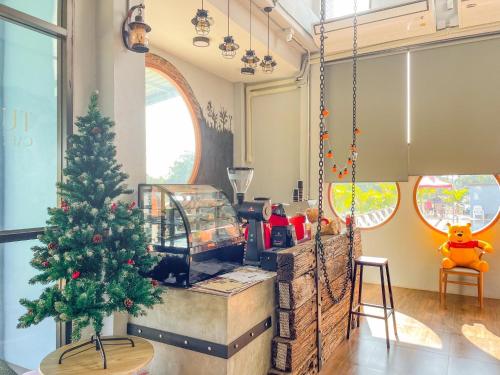 a christmas tree in a living room with a christmas tree at Tuscany Hotel Buriram in Buriram
