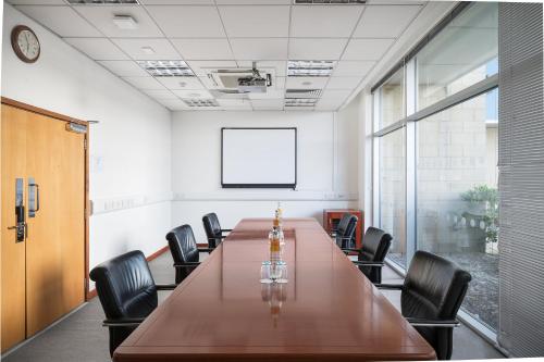 a conference room with a long table and chairs at voco Reading in Reading