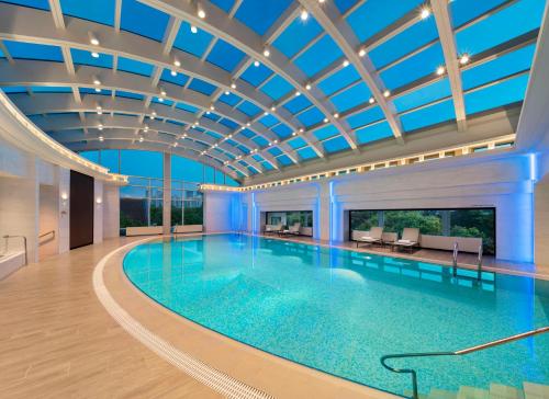a large swimming pool with a ceiling at Radisson Collection Hotel, Xing Guo Shanghai in Shanghai