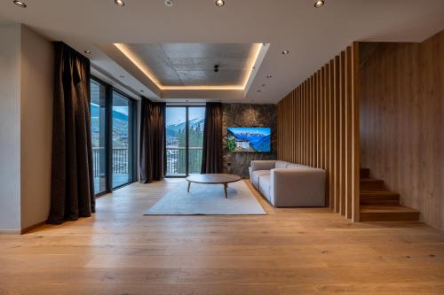 a living room with a couch and a table at Swissôtel Damian Jasna in Demanovska Dolina
