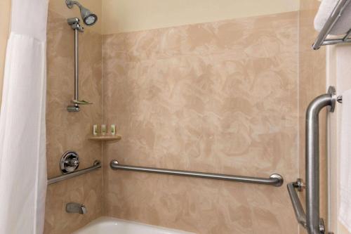 a bathroom with a shower with a shower curtain at Wingate by Wyndham Appleton in Appleton