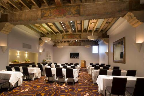 a banquet hall with white tables and chairs at Hotel De Anza in San Jose