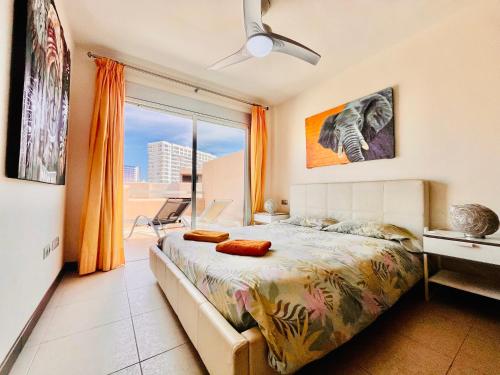 a bedroom with a bed and a large window at El Horno in Adeje