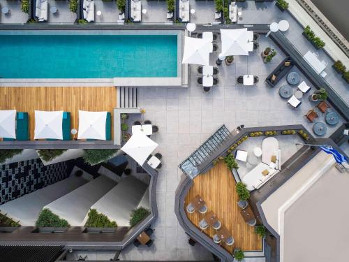 an overhead view of a hotel with a pool at Athens Capital Center Hotel - MGallery Collection in Athens