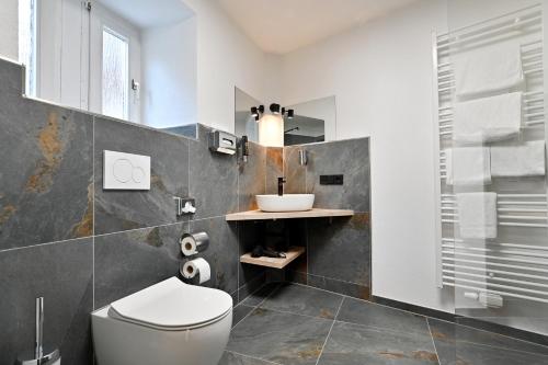 a bathroom with a toilet and a sink at Hotel Zehnthof in Cochem
