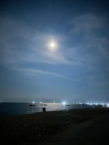 a moon over a beach at night at Homestay Beach View 2 in Phú Hiệp