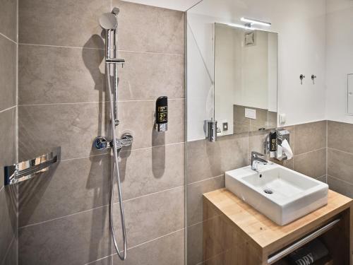 a bathroom with a shower and a sink at MyFavorit Apartments - Spacious Apartments next to Puplic Transport U1 direct connection to Citycenter in Vienna