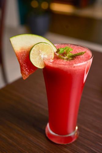 a drink with a slice of watermelon and a lime at Abad Fort in Cochin