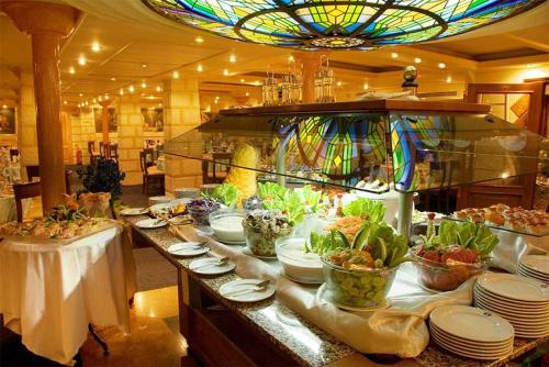 a buffet line with plates and bowls of food at M/s Nile crown II in Nag` el-Fuqâhi