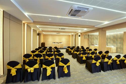 a room full of chairs with yellow and black bows at Abad Fort in Cochin
