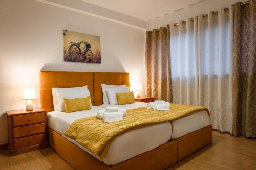 Un dormitorio con una cama grande con toallas. en Maria Benta House, en Ribeira Grande