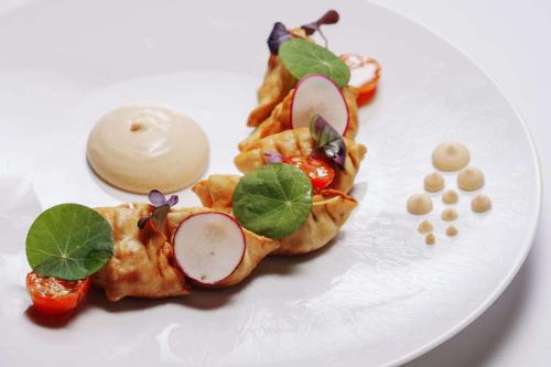 a white plate with food on top at Wyndham Grand Barbados Sam Lords Castle All Inclusive Resort in Saint Philip